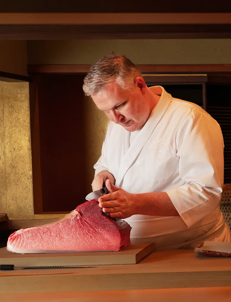 Chef Derek Wilcox preparing tuna at Miura Beverly Hills, practicing traditional Edomae sushi in Los Angeles